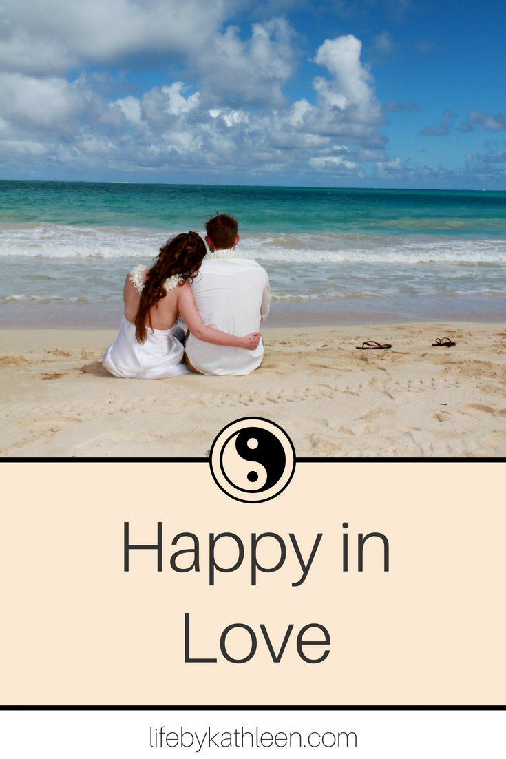 couple on a beach text overlay happy in love