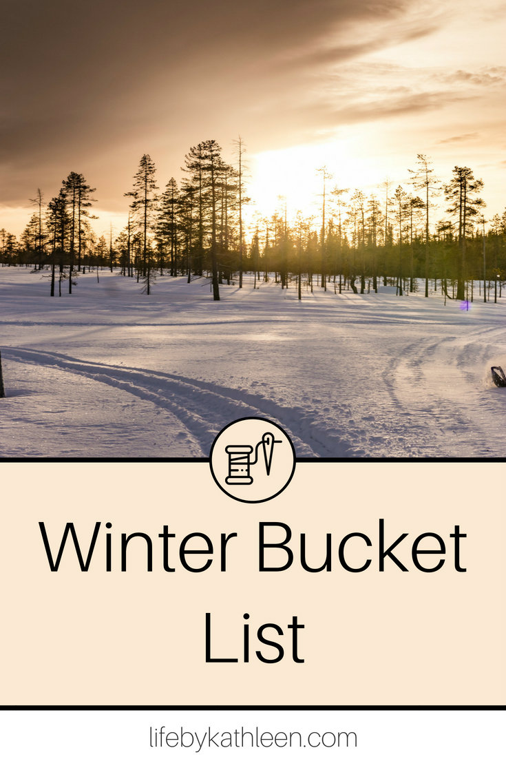 sunset over snow and trees text overlay winter bucket list